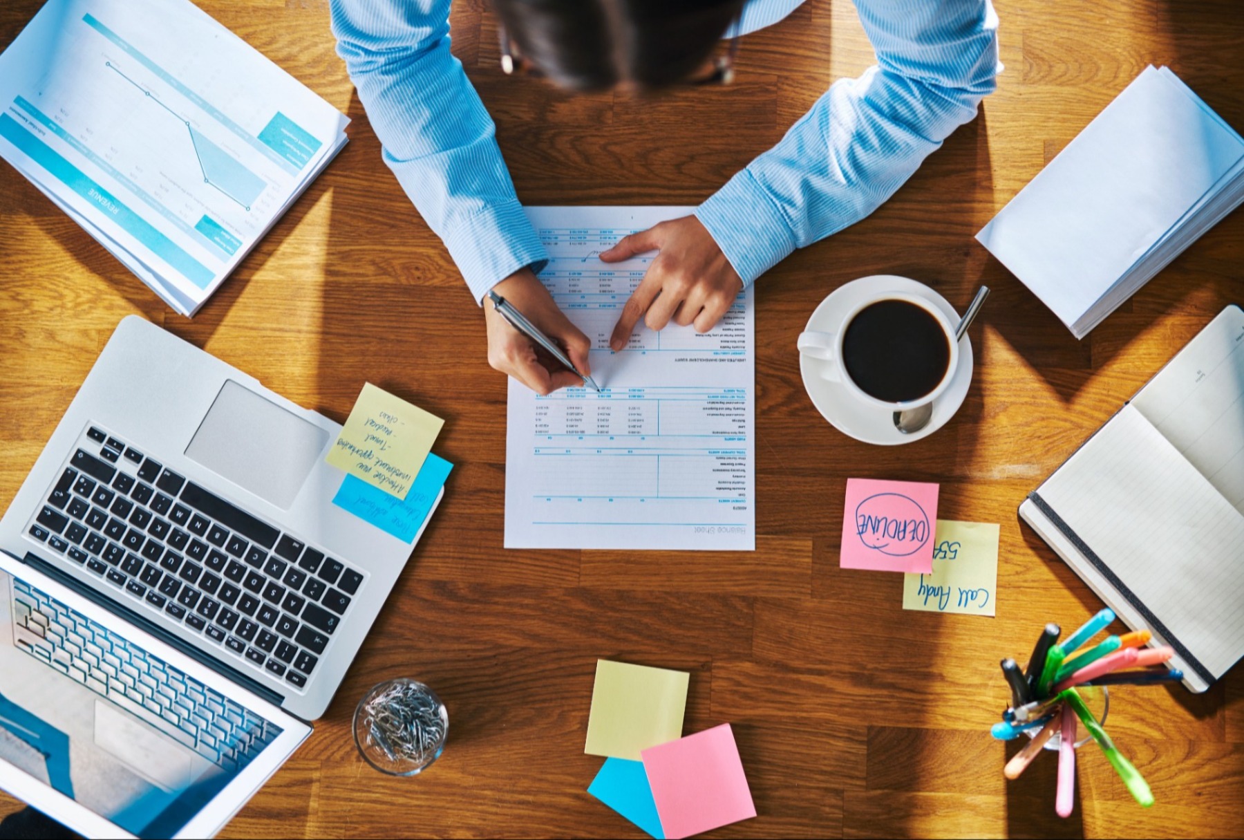 Business owner at desk analyzing documents