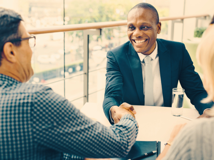 Banker and client shake hands