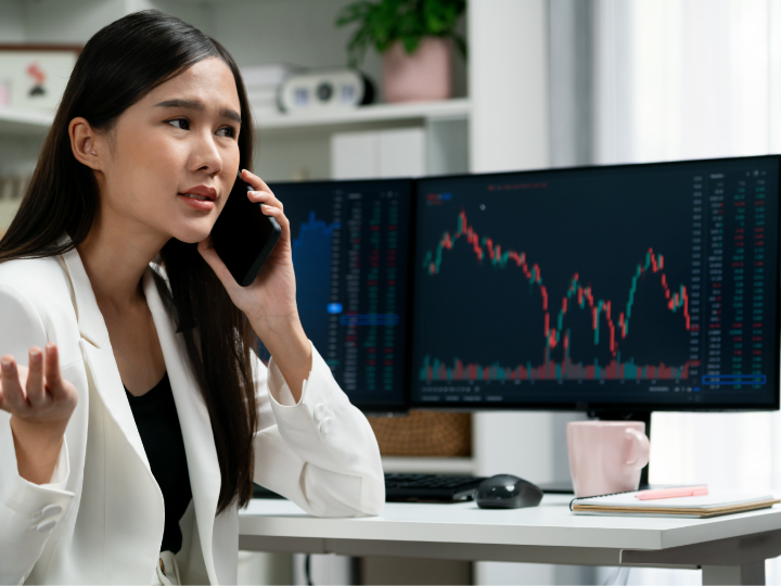 Business owner on phone with chart on computer