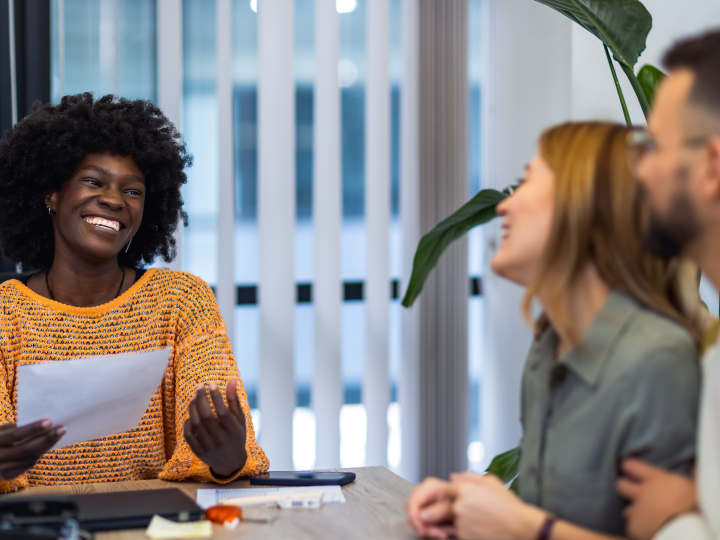 Banker and Clients Having Conversation at Desk