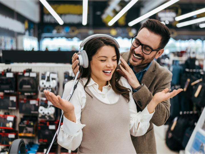 Couple in store trying headphones