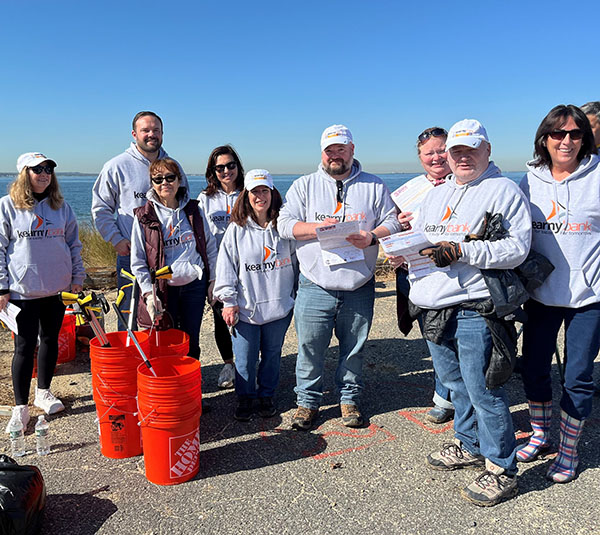 group of people picking up trash