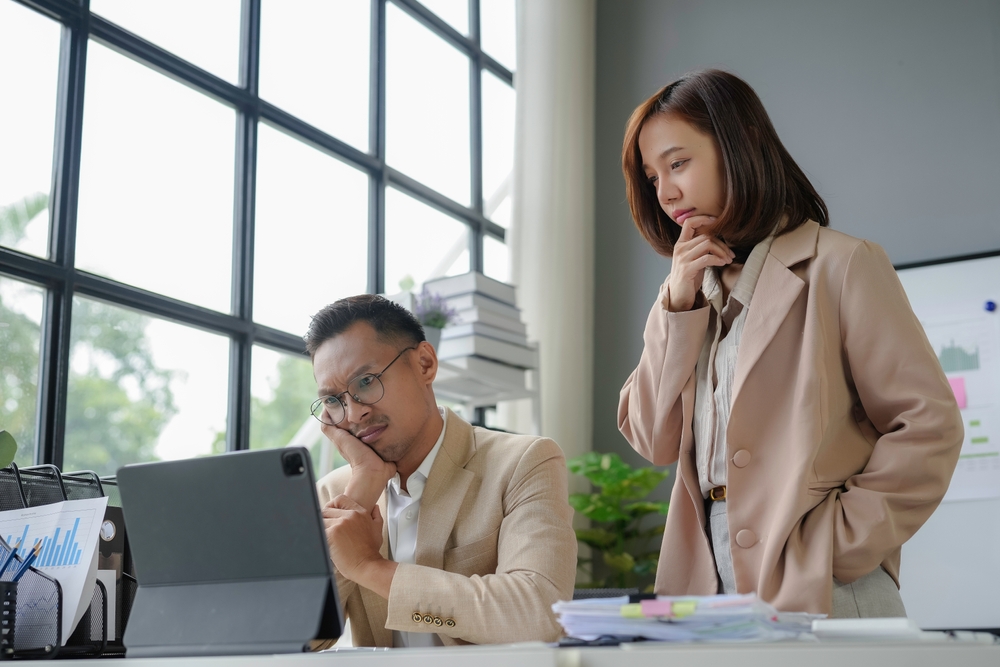 Man and woman studying laptop