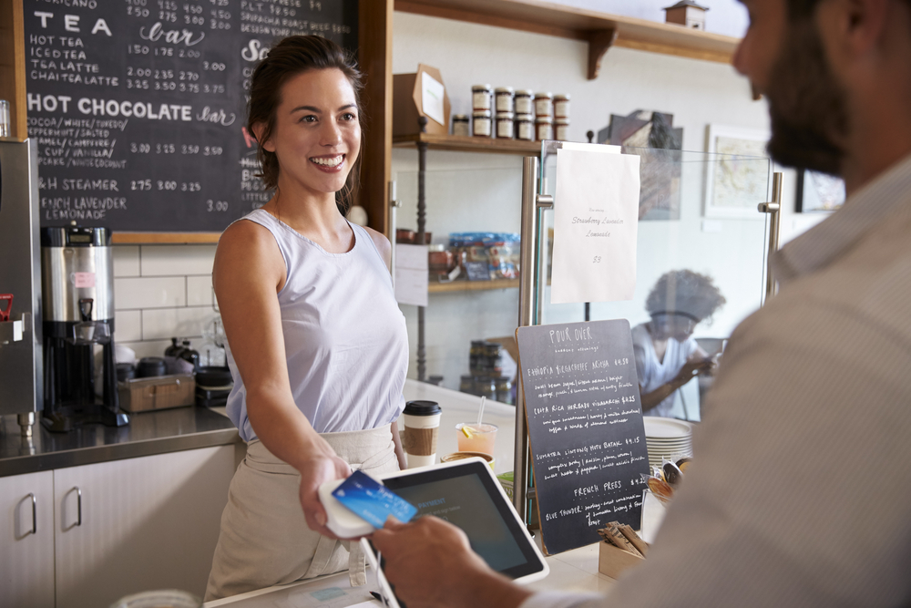 Coffee shop owner and customer card transaction