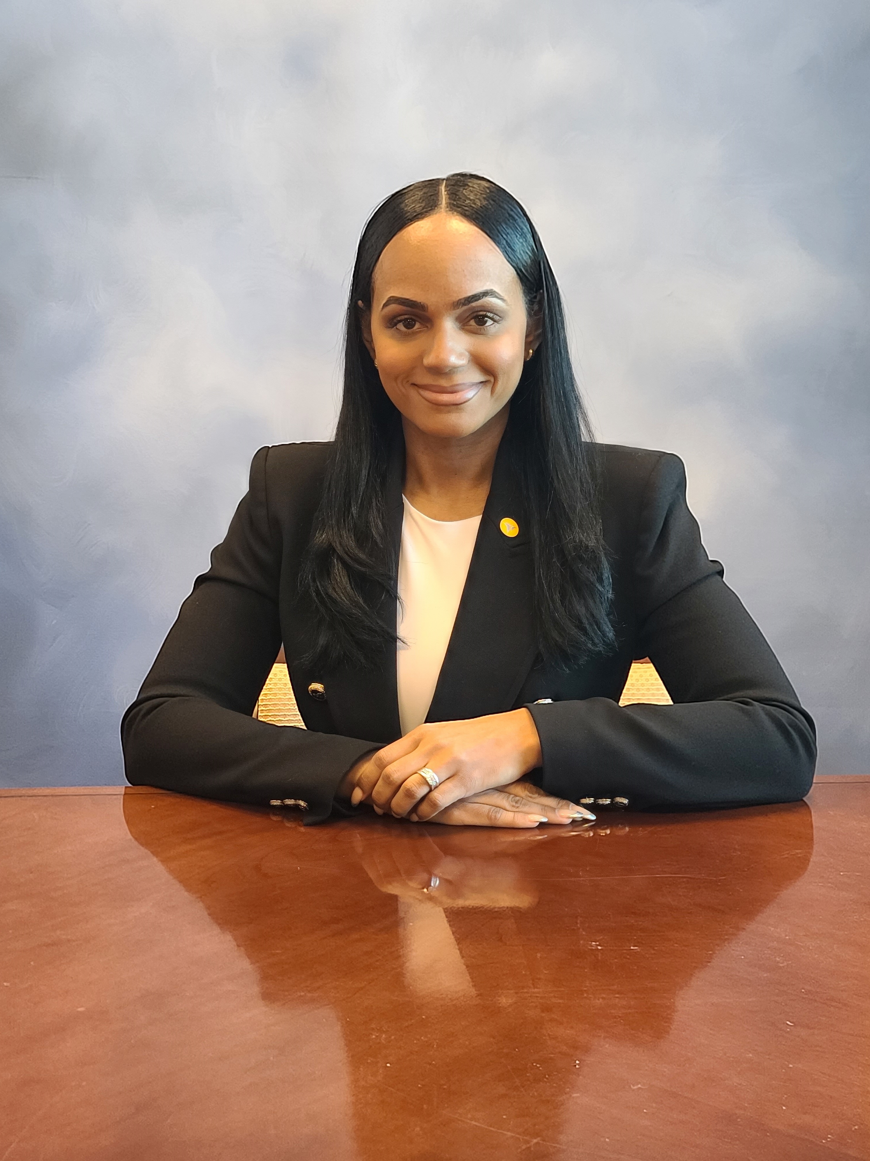 Headshot of a branch manager in formal office attire, seated