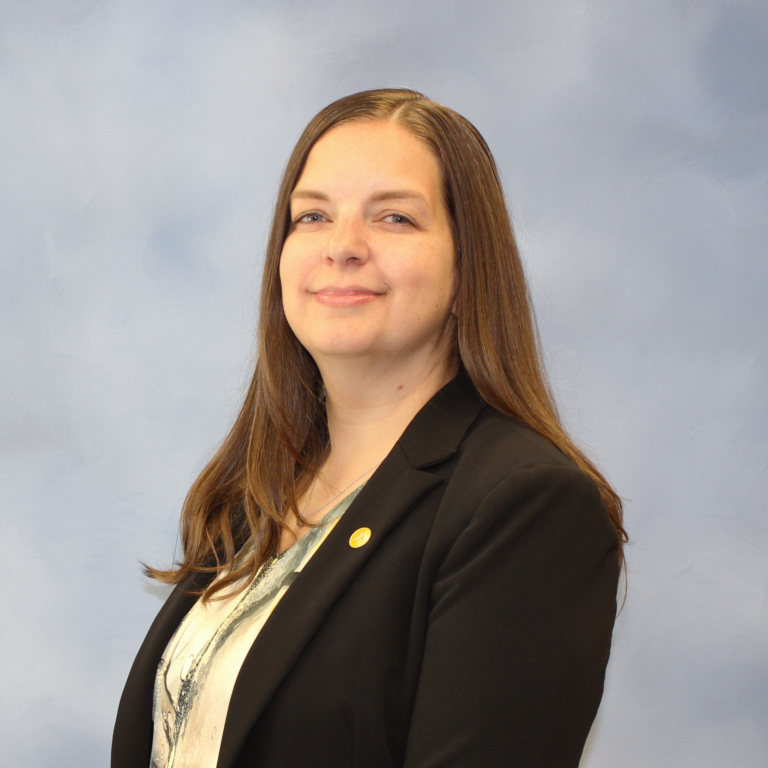 Branch manager seated at a desk for a professional photo