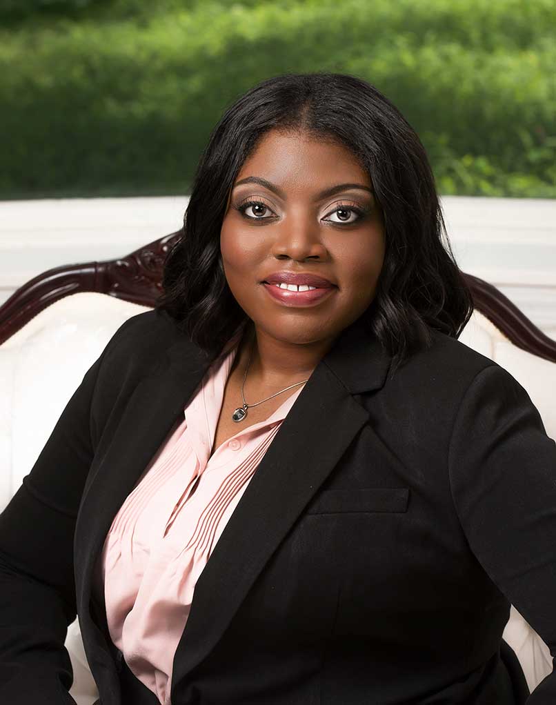 Branch manager sitting at a desk for a formal portrait