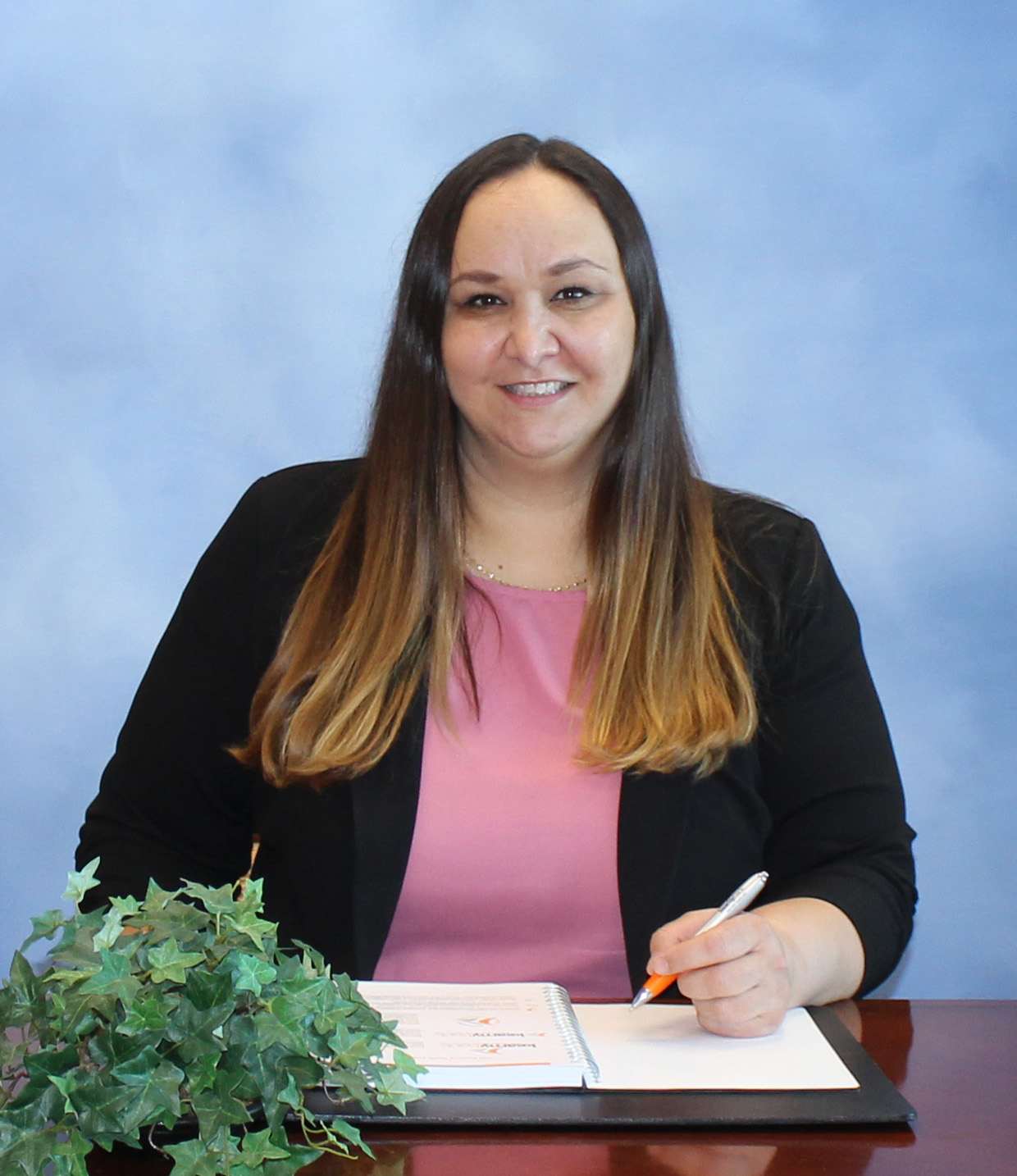 Branch manager in office attire, smiling for a headshot