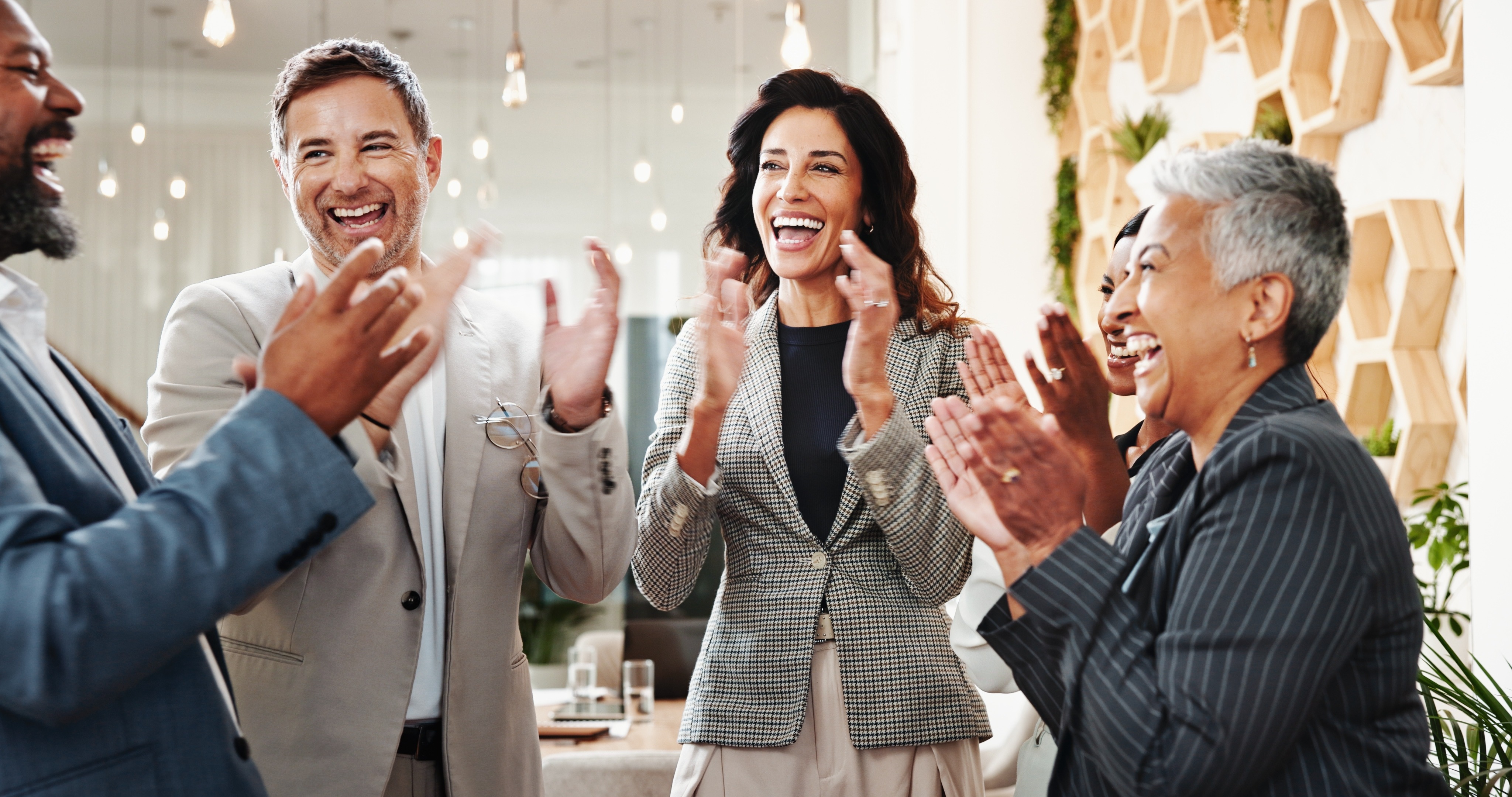 group of people celebrating, clapping