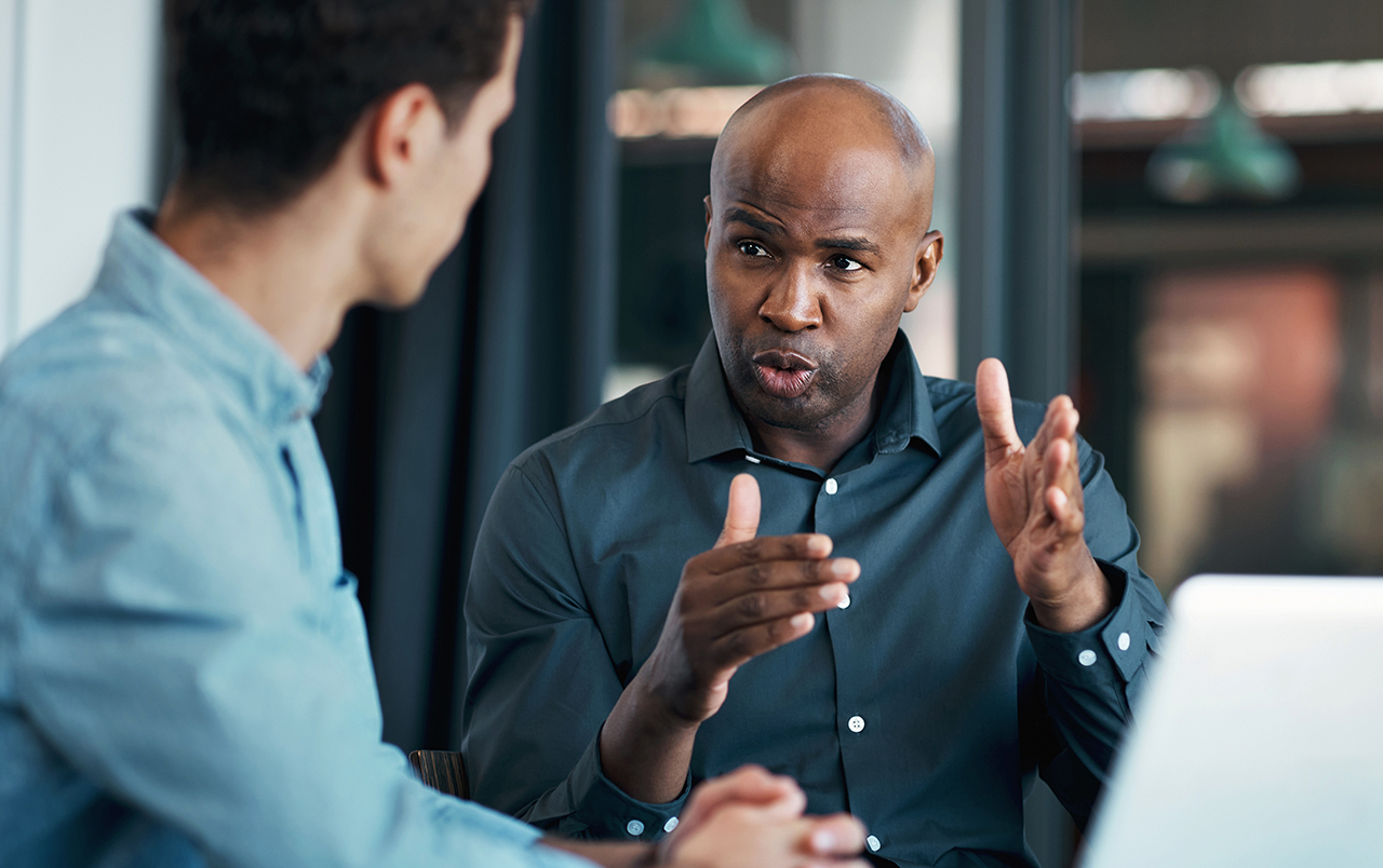 Men in a business meeting, having a serious conversation