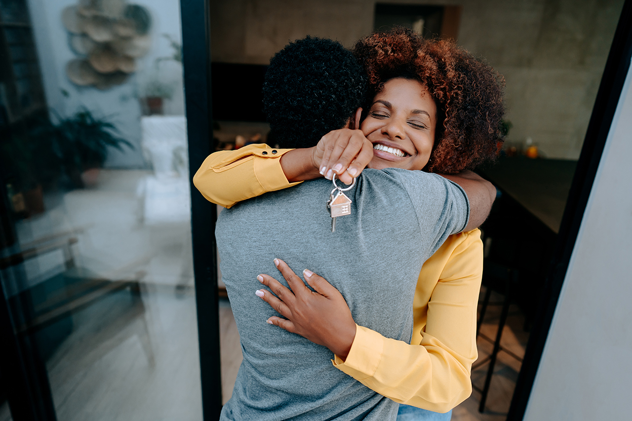 Young man and woman celebrating their new home