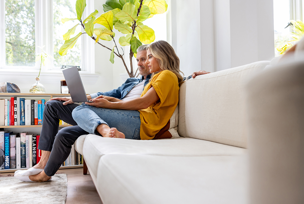 couple sitting together looking at laptop