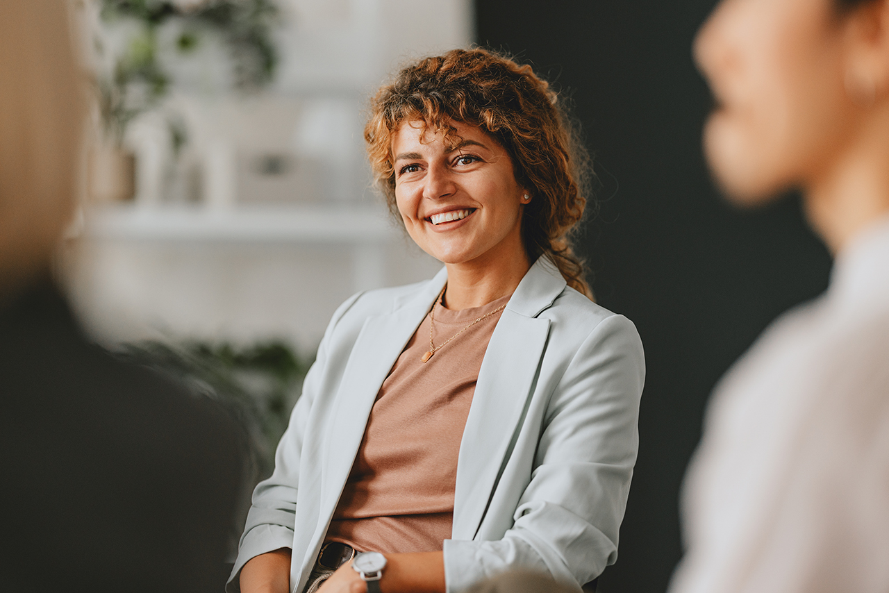 women sitting and smiling