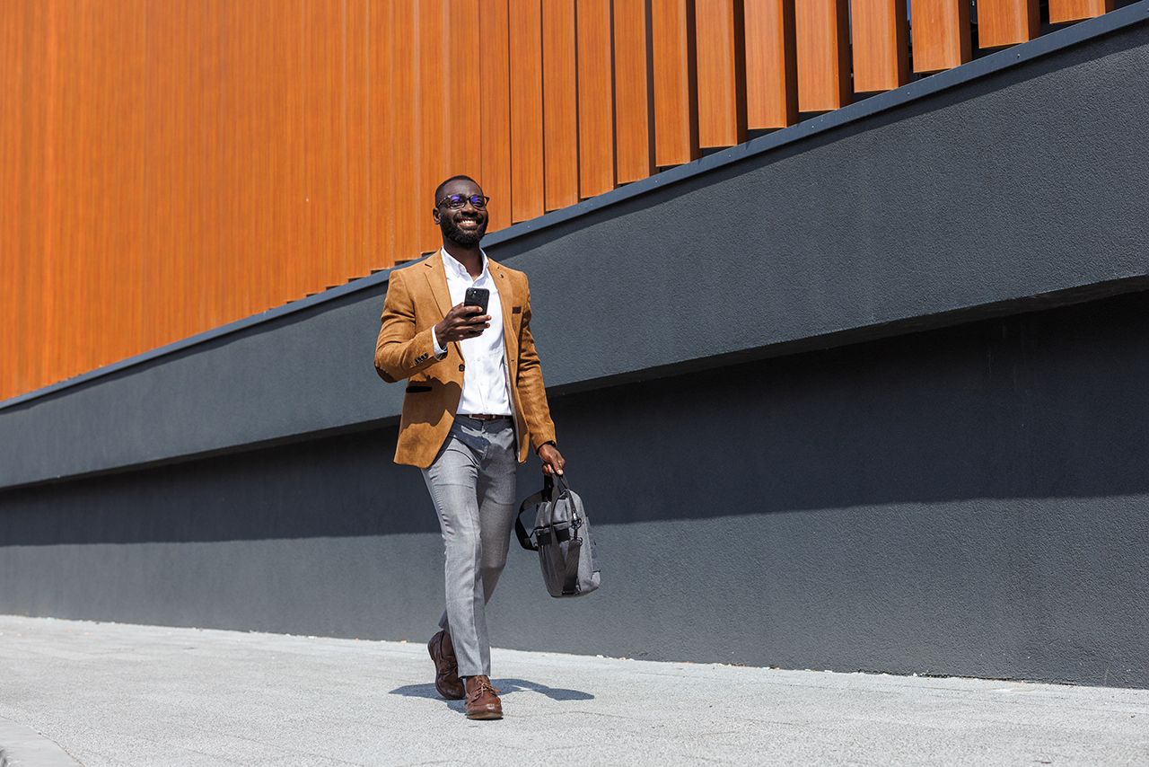 man walking and holding phone