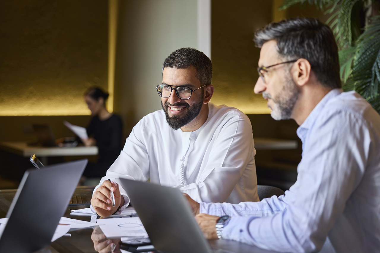 Two professionals having a meeting, discussing and reviewing documents