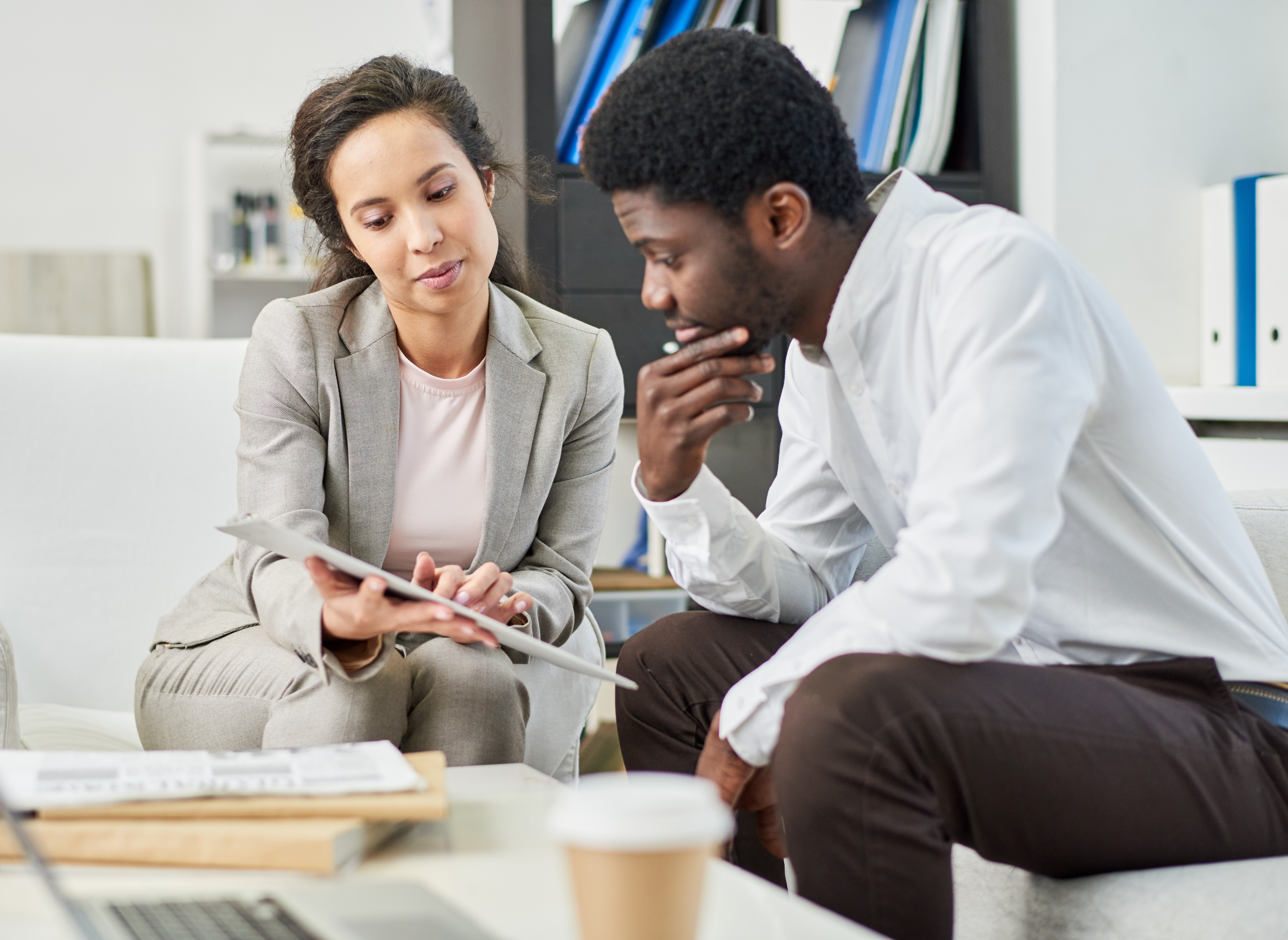 Businesswoman and man discussing papers