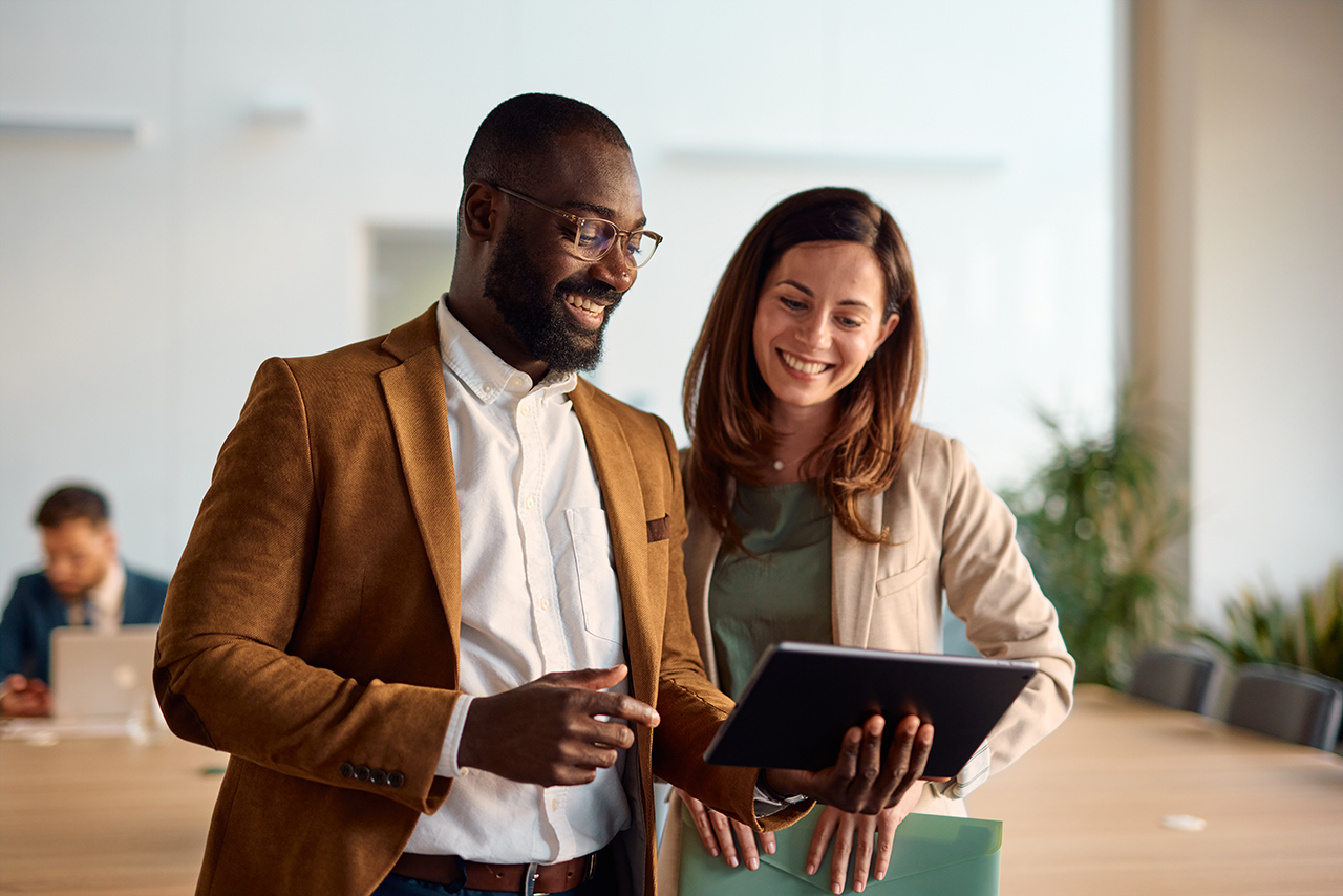 Businesswoman and man using a tablet
