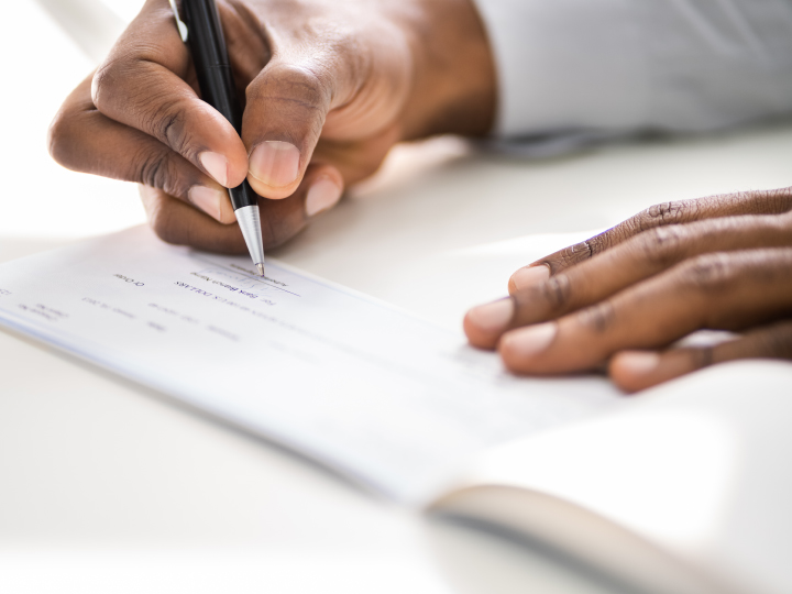 Woman signing a check