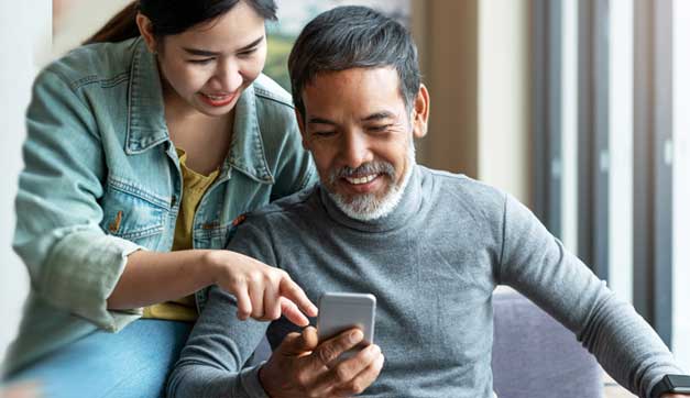 Woman discussing Digital Banking services on a mobile phone with a Man – Kearny Bank