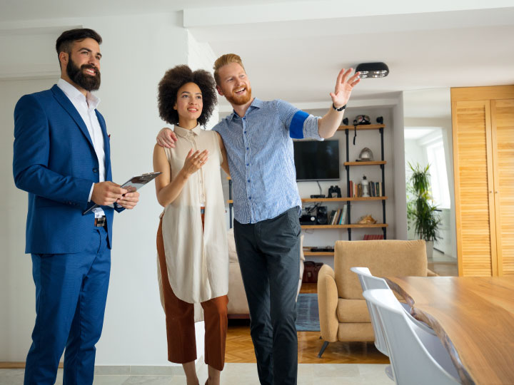 Three people standing in a house