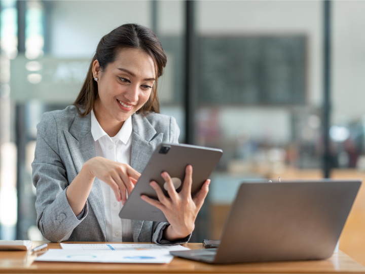 Business owner using tablet and laptop