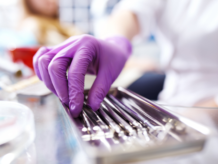 Dentist reaching for dental tools