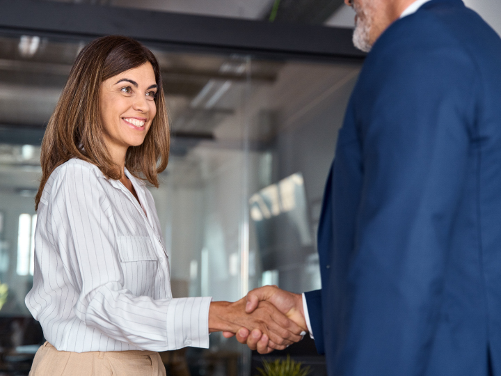 Caucasian business woman shaking business man's hand